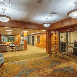 A well-lit lobby area with comfortable seating and decorative carpet.