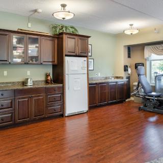 A modern kitchen featuring wooden cabinets, appliances, and a spacious layout.