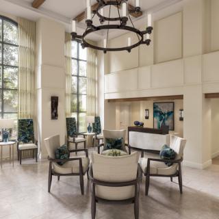A spacious and elegantly designed lobby with comfortable seating and a large chandelier.