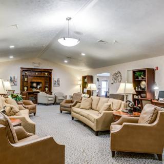A spacious living room with comfortable seating and warm lighting.