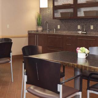 Modern kitchen and dining area with sleek cabinetry and seating.