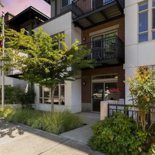 A modern urban apartment complex with balconies and well-maintained landscaping.