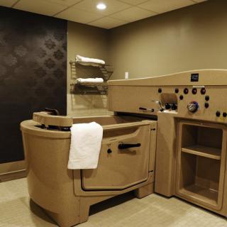 A serene spa room featuring a hydrotherapy tub for relaxation and wellness treatments.