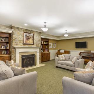 A cozy living room with comfortable seating and a fireplace.