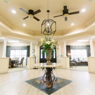 Spacious living area with elegant decor and a central floral arrangement.