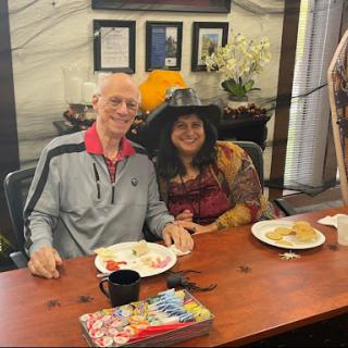 A cheerful couple enjoying a meal together.