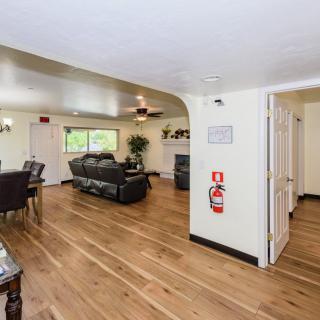 An open living and dining area with hardwood floors, featuring a comfortable sofa and a dining table.