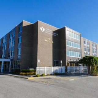 Exterior view of a modern hospital building on a clear day.