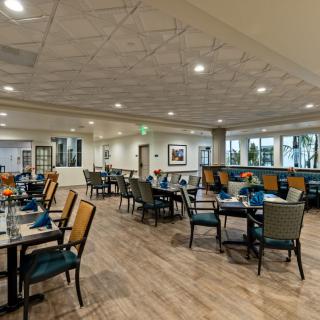 A spacious restaurant dining area with elegantly arranged tables and chairs.