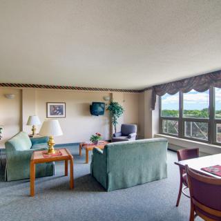 A spacious living room with large windows and comfortable seating.