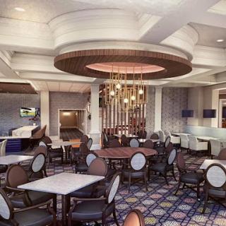 A stylish dining area featuring elegant furniture and modern lighting.