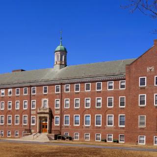 A historic brick building under a clear blue sky.