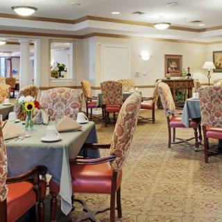 An elegantly decorated dining room with multiple tables and chairs.