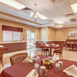 A beautifully arranged dining room with tables set for a meal.