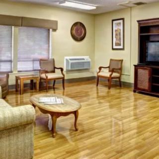 A cozy living room with wooden floors and comfortable seating.