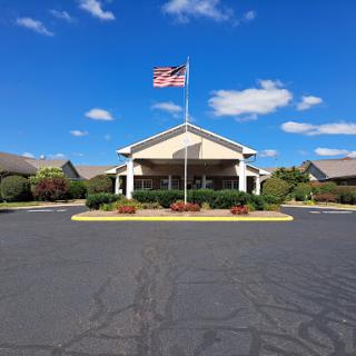 A picturesque view of a building with an American flag under a clear blue sky.