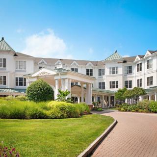 A luxurious hotel with well-maintained landscaping and a grand entrance.