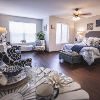 A modern and cozy bedroom with elegant decor, featuring a comfortable bed and stylish furnishings.