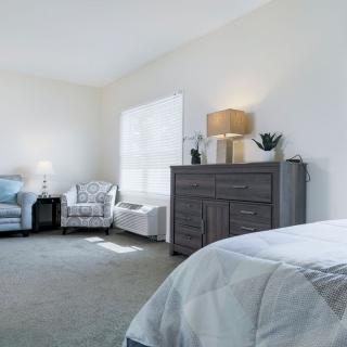 A bright and spacious bedroom with modern furniture and decor.