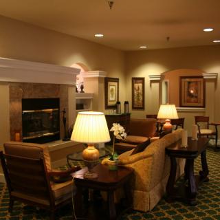A cozy living room with comfortable seating and warm lighting.