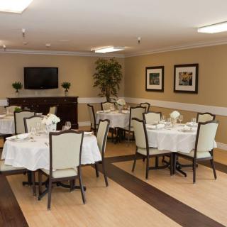 An elegant dining room with neatly set tables and chairs, ready for guests.