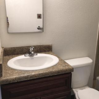 A small bathroom with a sink and toilet next to each other.