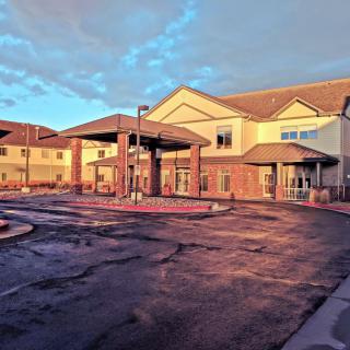 A large building with a prominent entrance, captured at sunset.