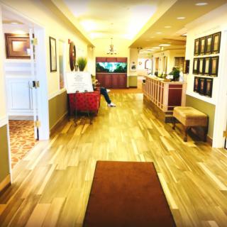 A bright hallway with a reception area and seating.