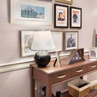 A stylish console table adorned with a lamp and framed art decorates the interior space.