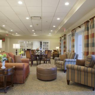 A cozy living room with comfortable seating and warm lighting.