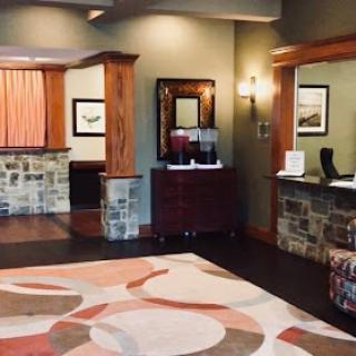 A welcoming hotel lobby featuring elegant wood and stone design elements.