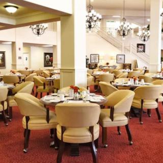 Elegant dining area with plush seating and chandeliers.