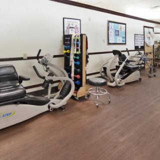 A fitness center with exercise machines lined up against the wall.