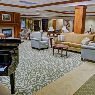 A spacious and elegantly furnished lobby with a grand piano and comfortable seating.
