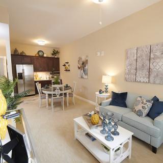 A modern open-concept living space featuring a cozy living room, dining area, and kitchen.