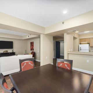 A modern open-space living room with a dining area and kitchen.