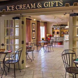 A cozy ice cream and gifts shop with seating area.