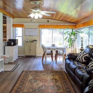 Cozy living and dining area with a wooden ceiling and natural light.