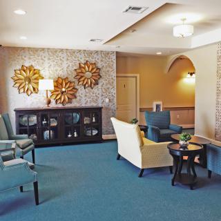 A modern and elegant living room with stylish furniture and decorative wall elements.