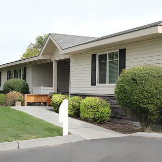 A suburban house with a well-maintained front yard and landscaping.