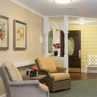 A cozy living room with comfortable seating and decorative artwork.