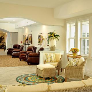 A spacious living room with armchairs and abundant natural light.
