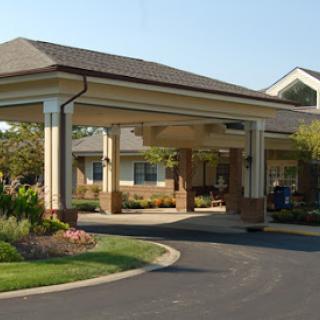A welcoming entrance of a residential building with beautiful landscaping.
