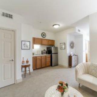 A cozy living area with a small kitchen and comfortable seating.