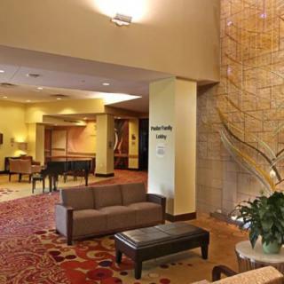 A spacious hotel lobby with seating arrangements and elegant decor.