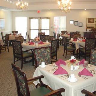 An elegantly decorated dining room with neatly arranged tables and chairs.