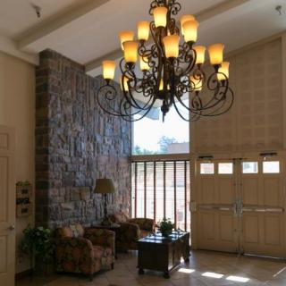 A welcoming lobby with a grand chandelier and comfortable seating.