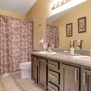 A neatly arranged bathroom with a double sink vanity and decorative elements.