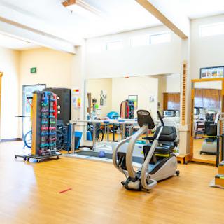 A well-equipped gym space designed for rehabilitation and fitness activities.