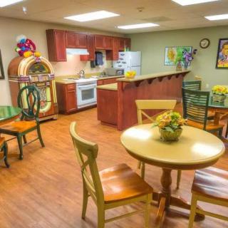 A cozy dining area with a retro jukebox and kitchen.